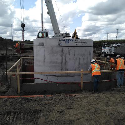 workers looking at pump chamber