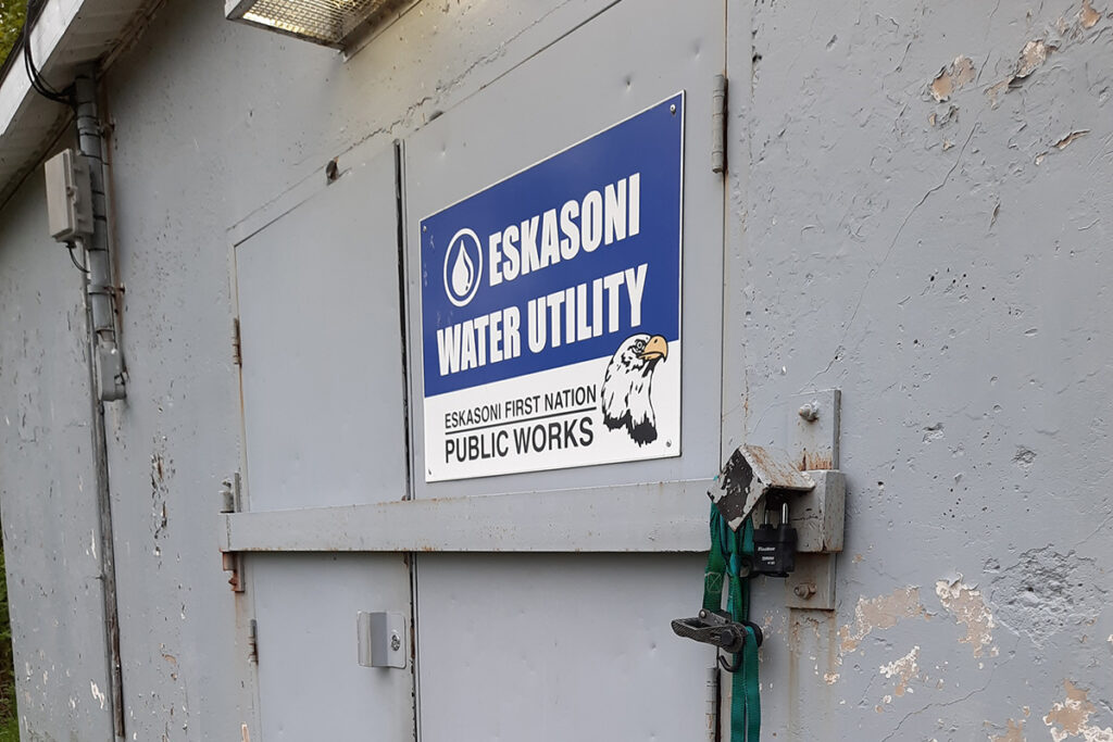 Eskasoni water utility sign on grey building