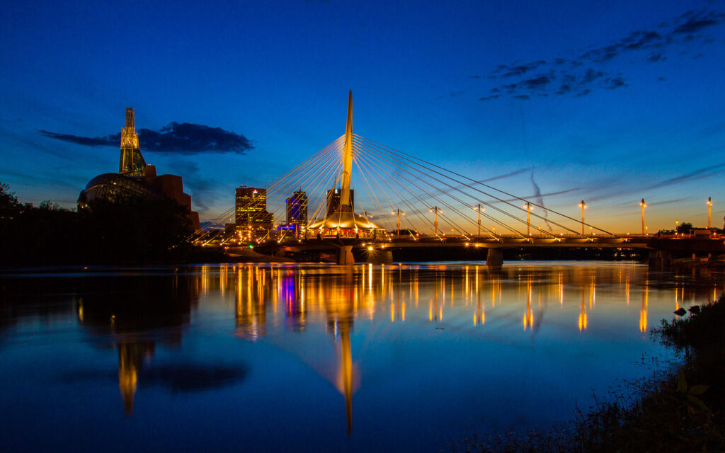 Provencher bridge in Winnipeg, Manitoba at sunset, city lights