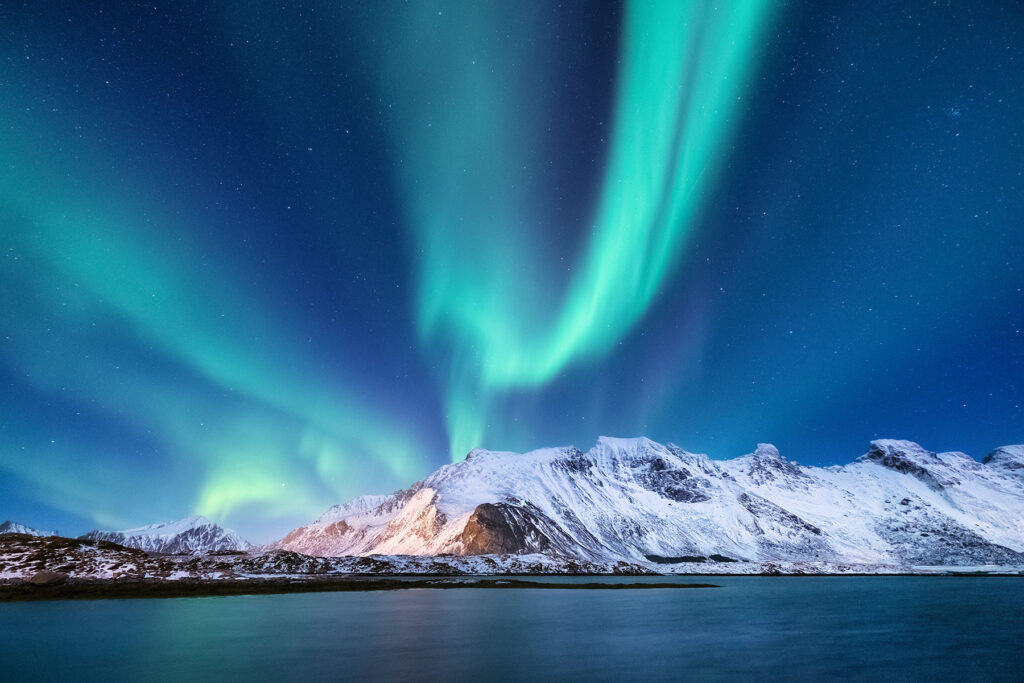 Northern lights above a snowy mountain in Northwest Territories