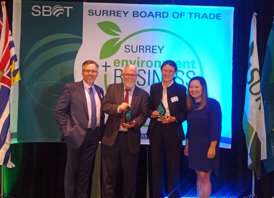 Group of professionals accepting an award from the surrey board of trade