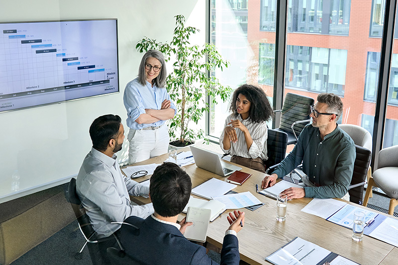 Group of people in a boardroom discussing a project