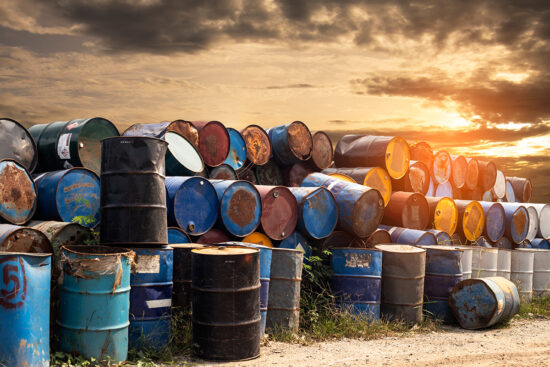 Discarded metal oil barrels stacked together