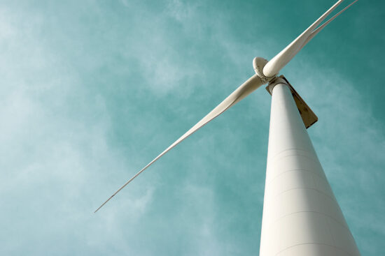 Photo of wind turbine looking up from the base of the tower