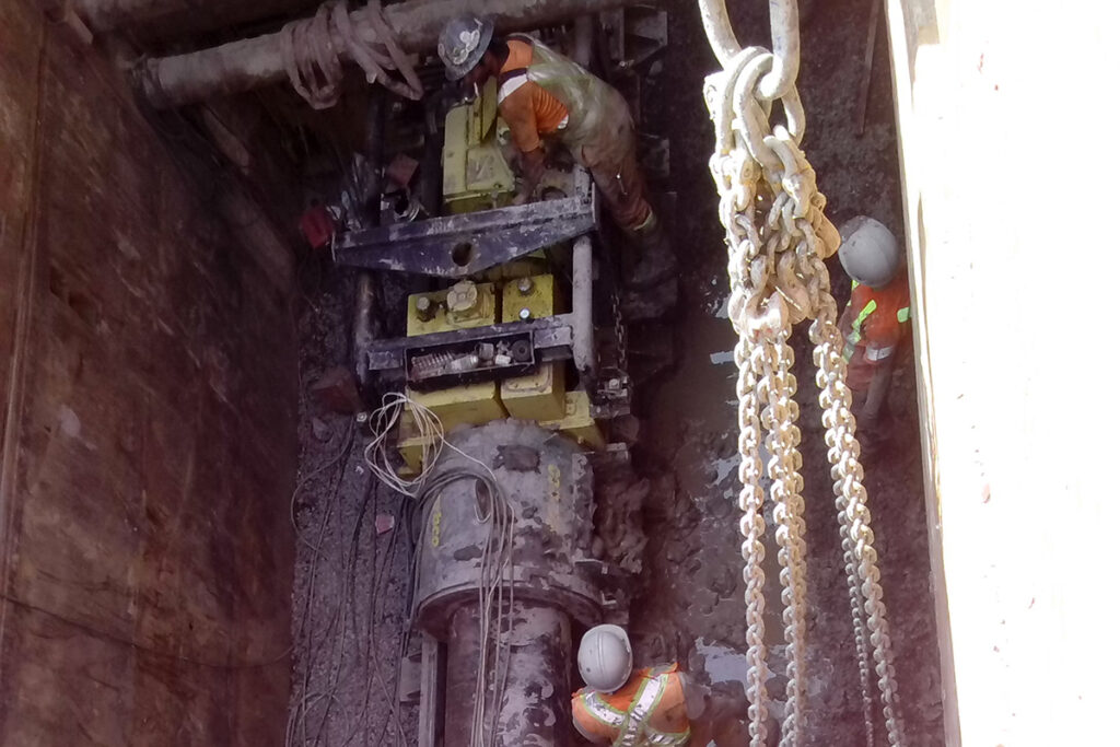 Men working in pit for pump station