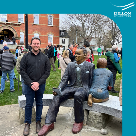 Young man standing beside John Peters Humphrey Statue